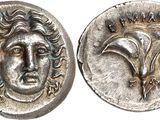 a close up of a coin with a face on it