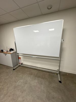 a white board in the corner of a room