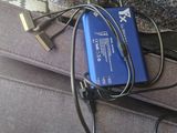 a blue power bank sitting on top of a gray couch