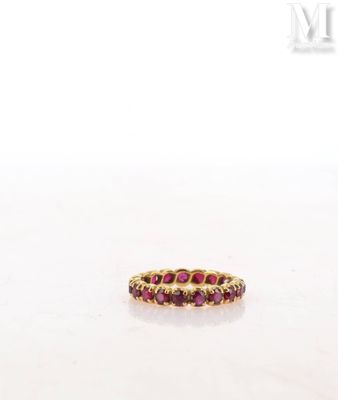 a close up of a gold ring with red stones