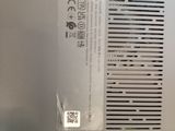 the back side of a silver laptop with a sticker on it