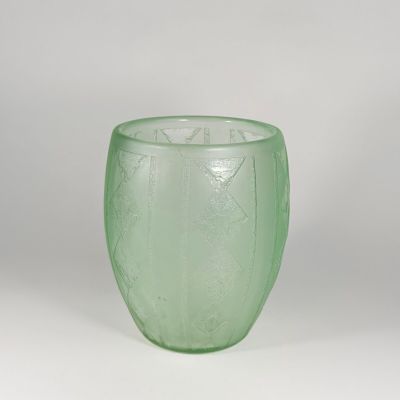 green glass vase on a white surface with a white background