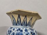 a blue and white vase sitting on a table