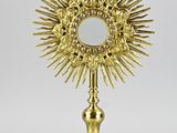 a gold plated crucif with a cross on top of it