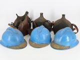 five blue helmets sitting next to each other on a white surface