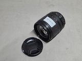 a camera lens sitting on the ground next to a camera lens cap
