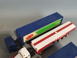 three toy trucks sitting next to each other on a table