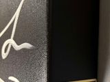 a picture of a black box with a signature on it