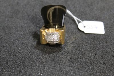 a gold ring with a diamond on it on a black surface