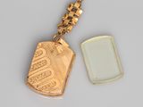 a gold dog tag with a green tag on it