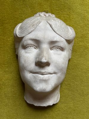 a white sculpture of a man with goggles on his head