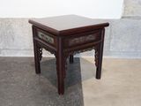 a small wooden table with a drawer on top of it