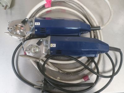 two electric tools that are sitting on a table