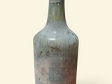 an old bottle that is sitting on a table