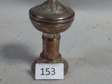 une image représentant un petit objet métallique surmonté d'une croix