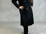 the girl is wearing a black coat and black pants