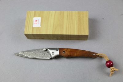 a knife that is laying on a table next to a box