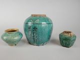three vases sitting next to each other on a white surface