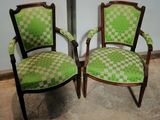 two chairs that are sitting next to each other