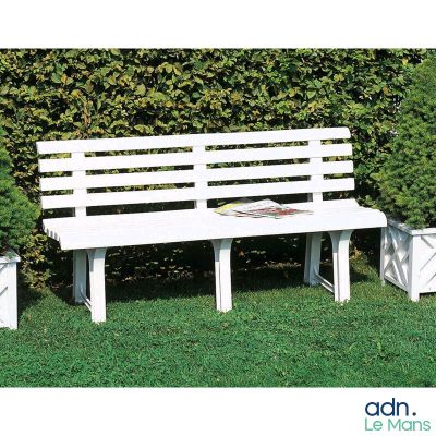 un banc blanc posé au milieu de la pelouse