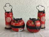 three red vases that are sitting on a table