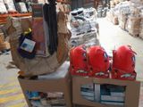 a cart full of luggage sitting on the floor in a warehouse