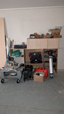 a room with a lot of clutter and tools on the floor