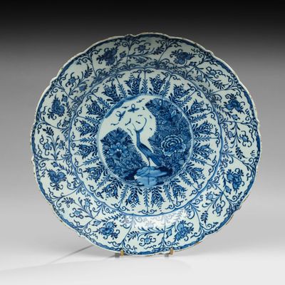 assiette bleue et blanche représentant un oiseau perché sur une branche d'arbre