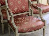 four chairs sitting next to each other in a room
