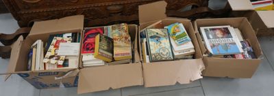 many boxes of books sitting on the floor next to a dresser