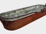 a rusted metal tub with a handle on it
