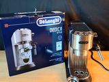 a coffee maker sitting on a table next to a box of coffee