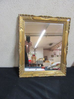 a person taking a picture of a mirror with a cell phone