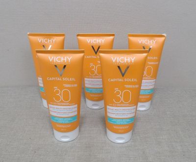 quatre flacons de crème solaire Vichy Capital Sun posés sur une table
