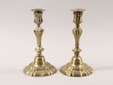 pair of antique brass candlesticks on a white background