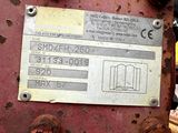a sign on the side of a rusted machine