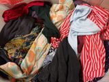 a pile of clothes sitting on the floor next to a chair