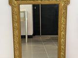 a mirror that is sitting on the floor in a room