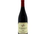 a close up of a bottle of red wine on a white background