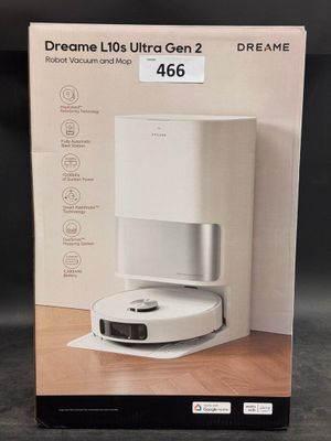 the box of a white coffee maker on a wooden table