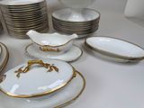 a lot of plates and bowls that are on the table
