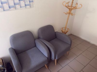 two chairs that are sitting next to each other in a room