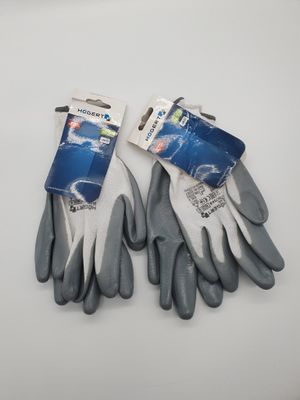 two pairs of gardening gloves on a white surface