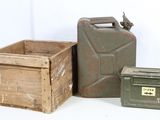 two old jerry cans and a wooden box on a white surface