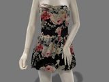 female mannequin wearing a black and pink dress with flowers on it