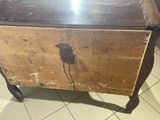 a wooden box with a bird on it sitting on a tiled floor
