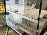 an image of a bakery display case with donuts in it