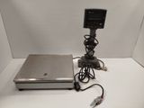 a laptop sitting on top of a table next to a digital scale