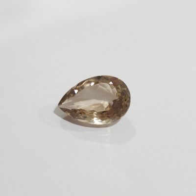 a close up of a brown diamond on a white surface
