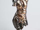 bronze statue of a woman on a pedestal on a white background